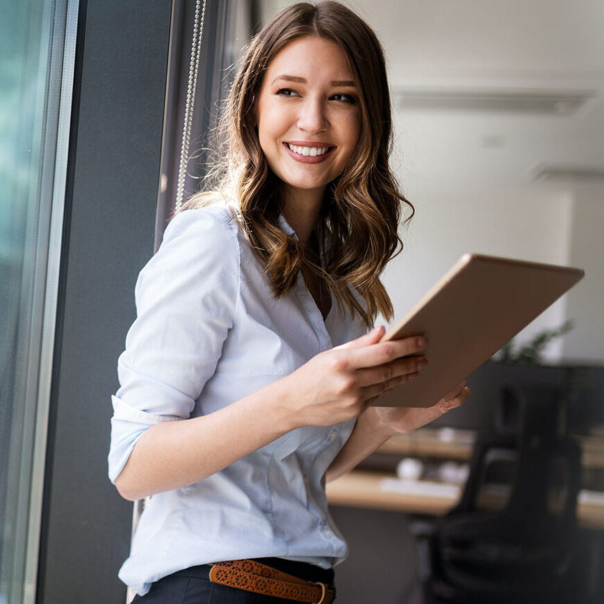 Successful young business woman looking confident and smiling