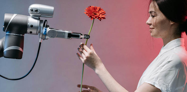 Woman receiving a red flower from a robotic arm